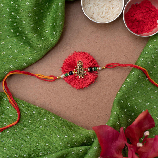 Handmade Lord Krishna charm Rakhi with pearl embellishments on Red cotton thread  - Gold, Red