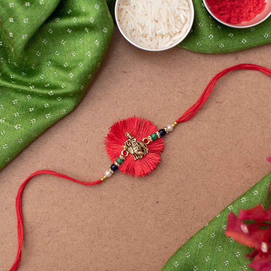 Handmade Lord Krishna & cow charm Rakhi with pearl embellishments on Red cotton thread  - Gold, Red