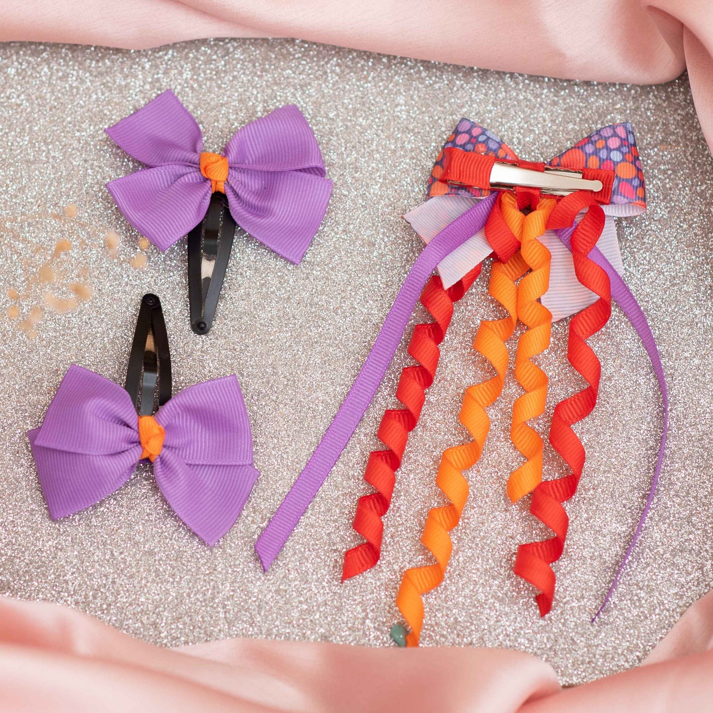Combo: Cute dangler on alligator clip along with cute and fancy bow on tic-tac pins - Purple, Red, and Orange